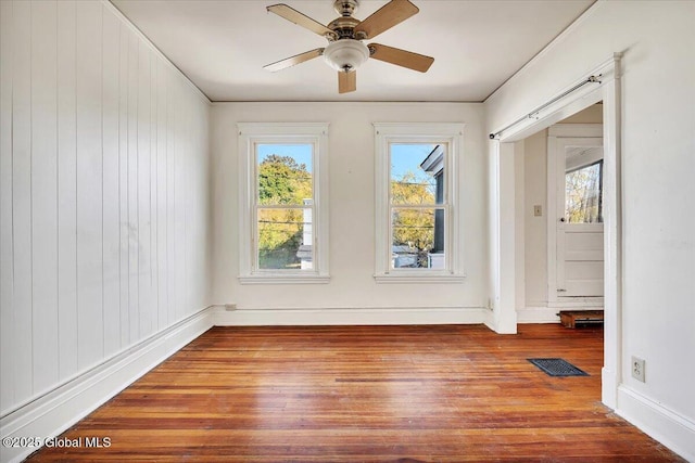 unfurnished room featuring hardwood / wood-style flooring and ceiling fan