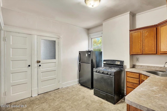 kitchen featuring ornamental molding, sink, and black appliances