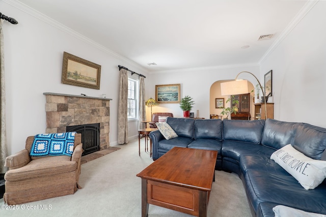 carpeted living room with a stone fireplace and ornamental molding