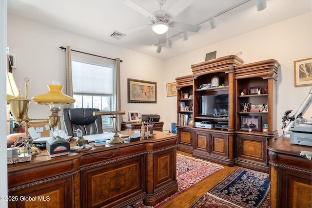 home office featuring hardwood / wood-style flooring, rail lighting, and ceiling fan