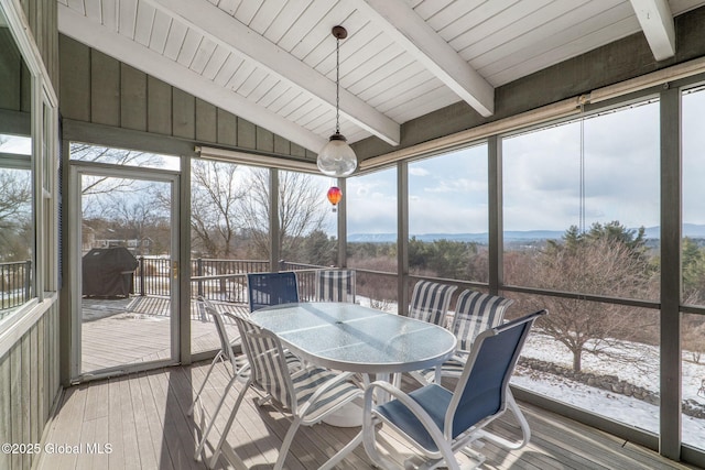 sunroom / solarium with lofted ceiling with beams