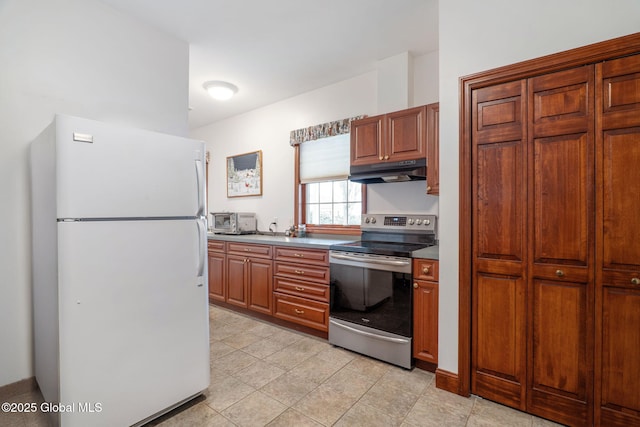 kitchen featuring stainless steel electric range oven and white fridge