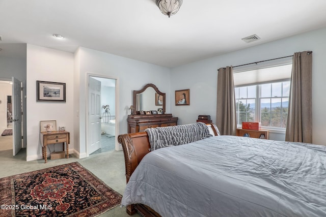 carpeted bedroom featuring connected bathroom