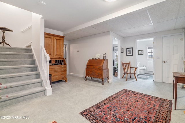 interior space featuring light carpet and a drop ceiling