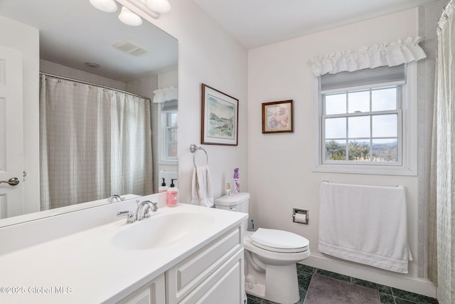 bathroom featuring vanity, toilet, and tile patterned flooring