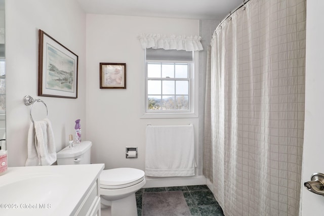 bathroom featuring vanity, tile patterned flooring, and toilet