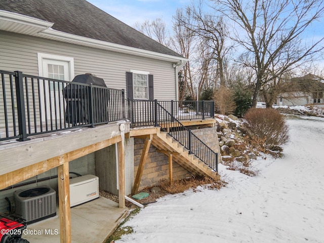 snow covered deck featuring cooling unit