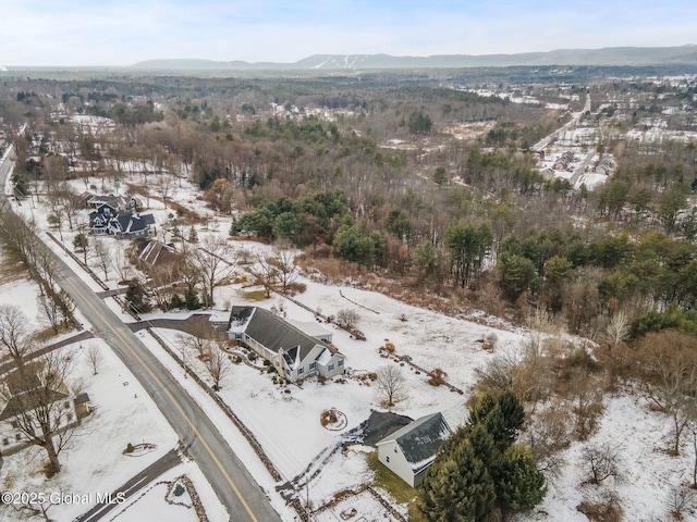 snowy aerial view with a mountain view