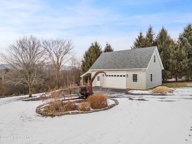 view of snow covered exterior featuring a garage