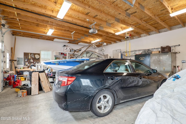 garage with a garage door opener and electric panel