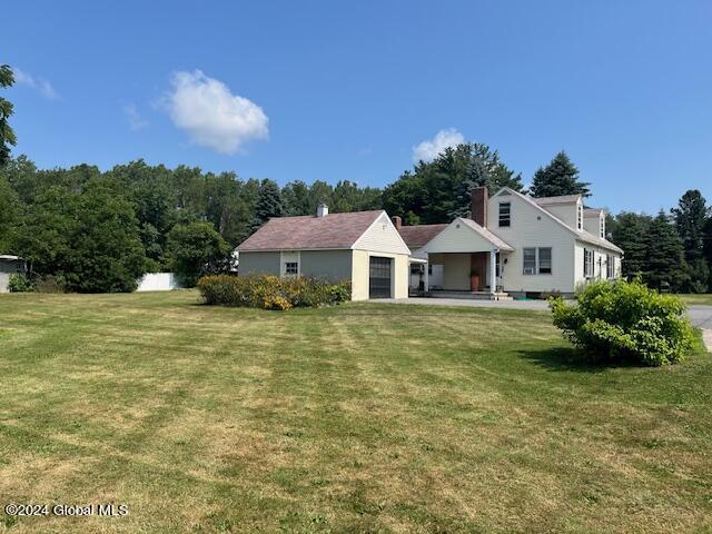 view of front of property with a front yard and a garage