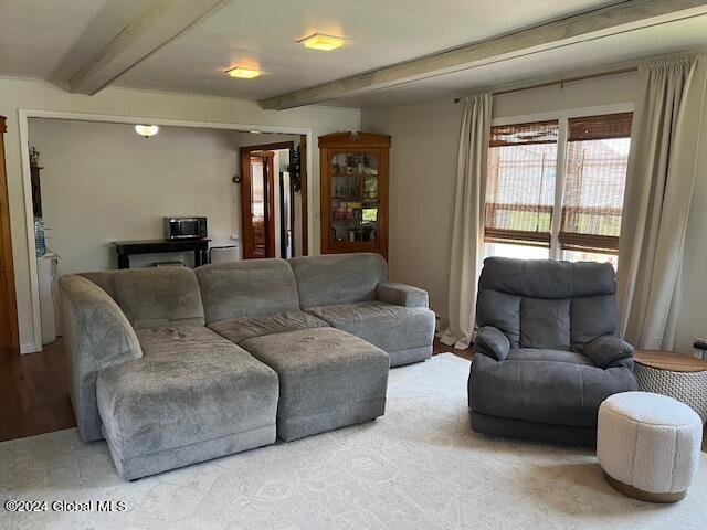 living room featuring beamed ceiling