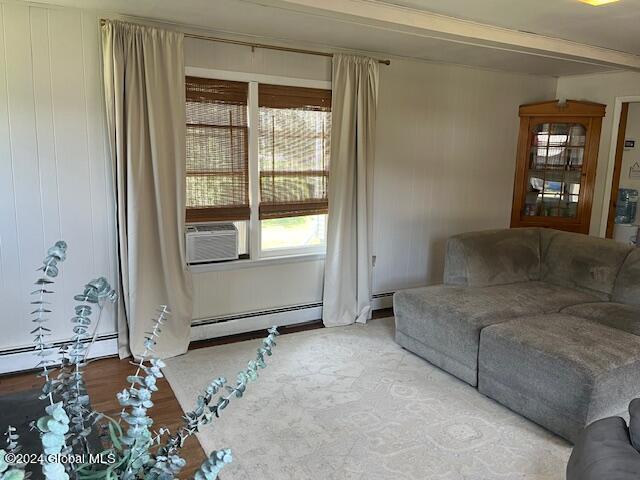 living room featuring cooling unit and a baseboard heating unit