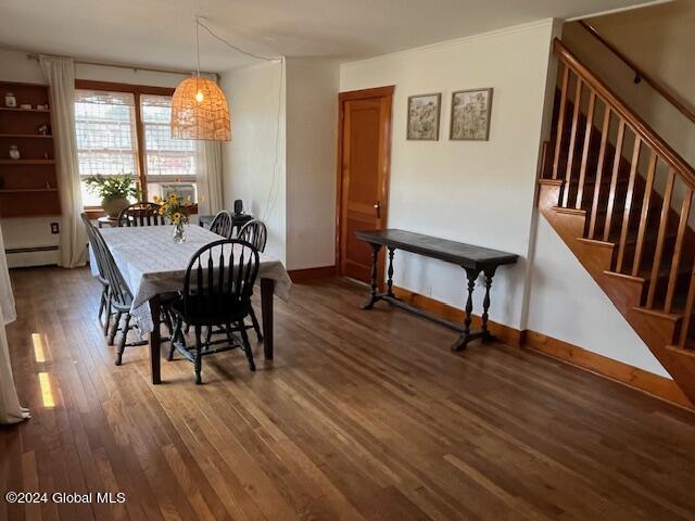 dining space featuring a baseboard radiator and dark wood-type flooring