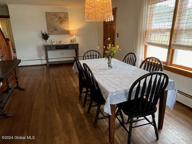 dining room featuring dark hardwood / wood-style flooring and an inviting chandelier