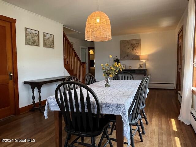 dining area featuring baseboard heating and dark wood-type flooring