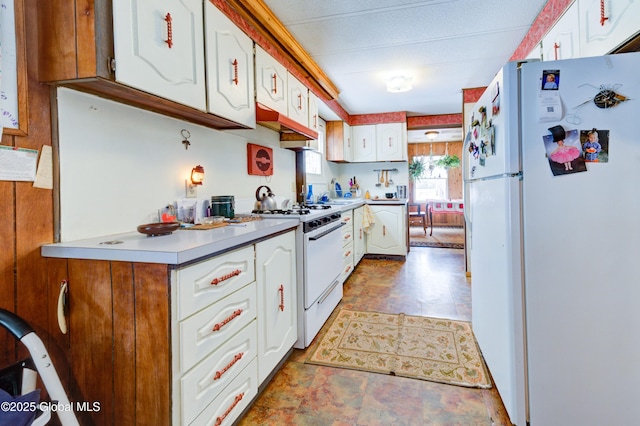 kitchen with white appliances and white cabinets