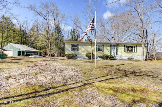 758 S Shore Rd E, Caroga Lake, Caroga, NY 12032 - view of front of property with a garage, an outbuilding, a front lawn, and a chimney