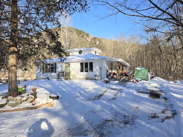 view of snow covered back of property