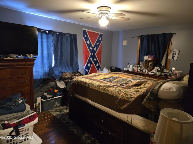 bedroom with dark hardwood / wood-style floors and ceiling fan