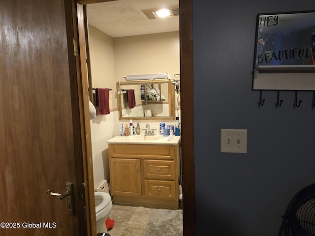 bathroom with vanity and toilet