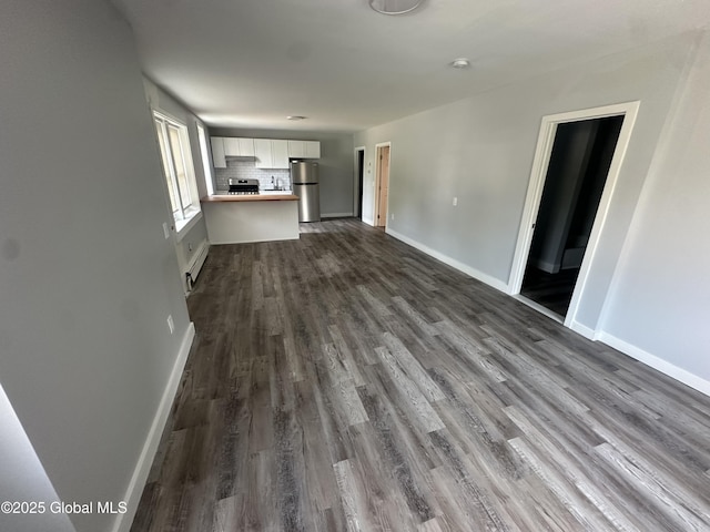 unfurnished living room featuring dark hardwood / wood-style flooring