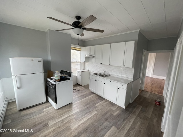 kitchen with sink, white appliances, white cabinets, and light hardwood / wood-style flooring