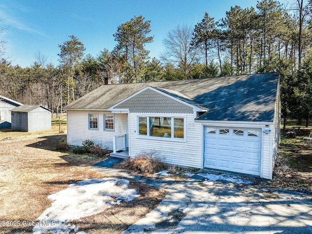 ranch-style home with an attached garage, an outdoor structure, a storage shed, and driveway