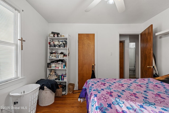 bedroom featuring multiple windows, wood-type flooring, and ceiling fan