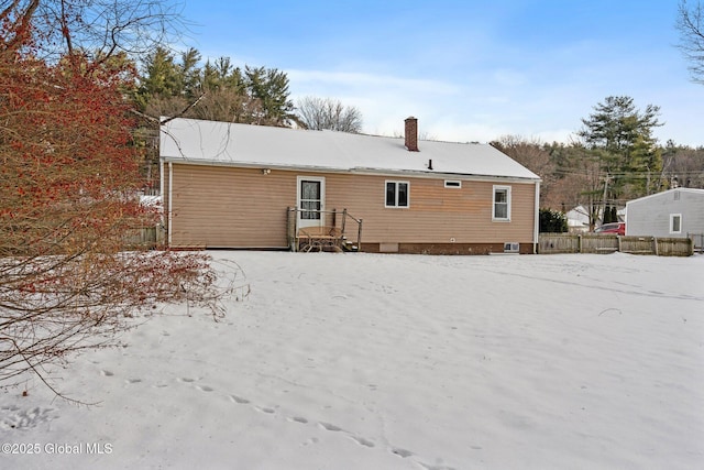 view of snow covered rear of property