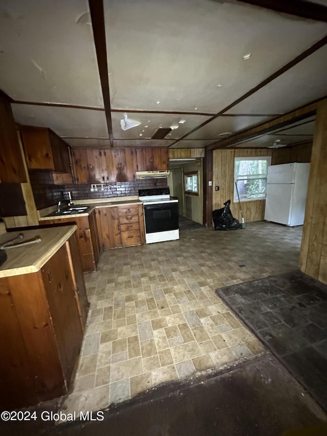 kitchen featuring sink, white refrigerator, and range with electric stovetop