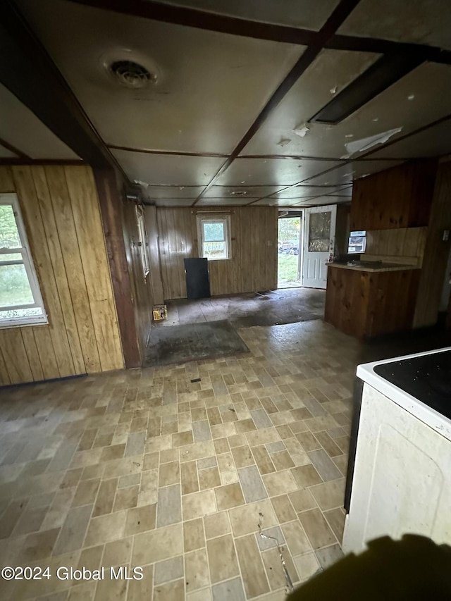 kitchen featuring white electric range and wood walls