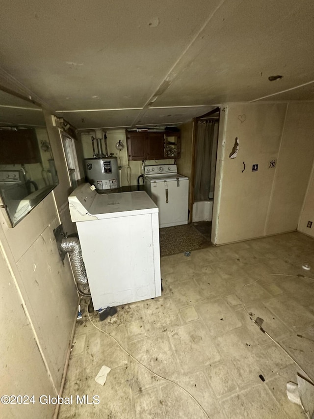 clothes washing area featuring washer and clothes dryer and water heater