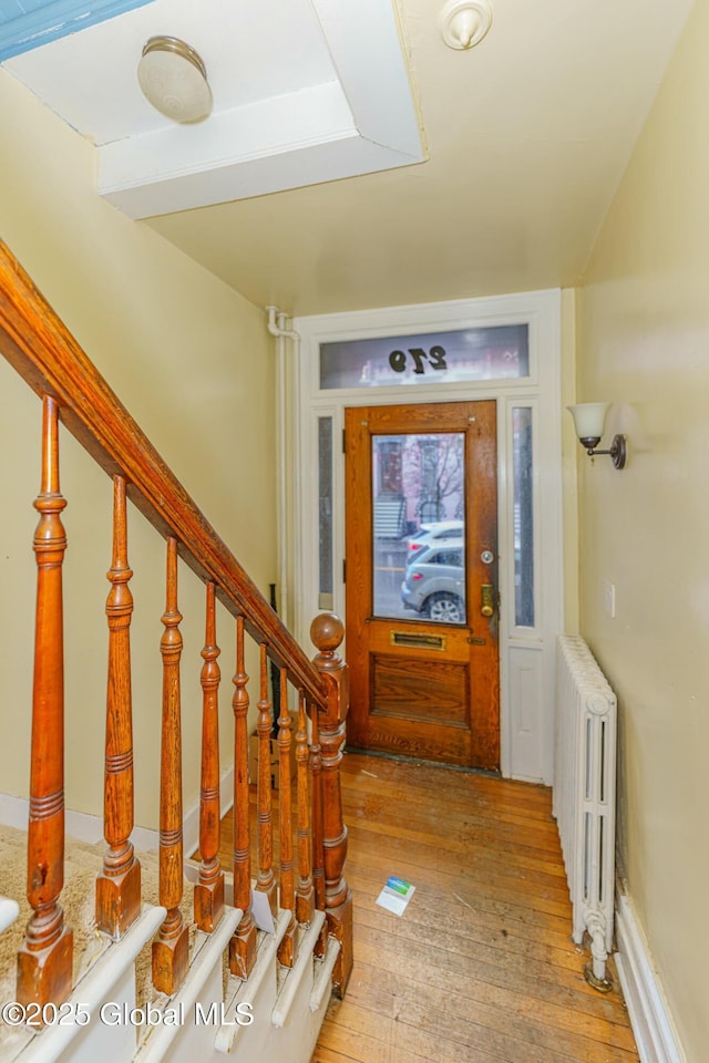 foyer featuring radiator and light hardwood / wood-style floors