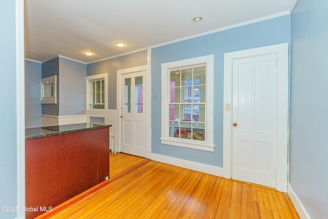 kitchen featuring ornamental molding and light wood-type flooring