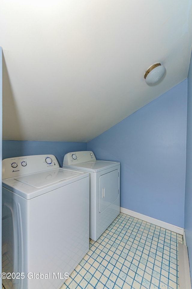 clothes washing area with washing machine and dryer