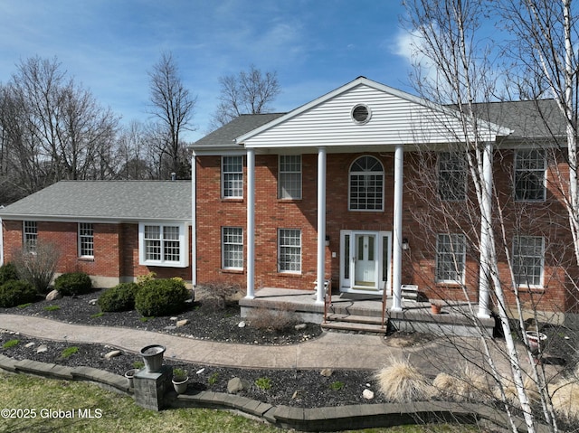 987 Grooms Rd, Rexford, NY 12148 - greek revival house featuring brick siding, a shingled roof, and covered porch