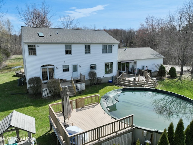 987 Grooms Rd, Rexford, NY 12148 - back of house featuring roof with shingles, a covered pool, a deck, and a lawn