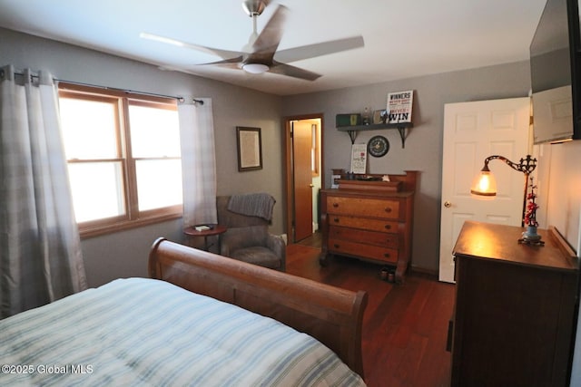 bedroom with ceiling fan and dark hardwood / wood-style flooring