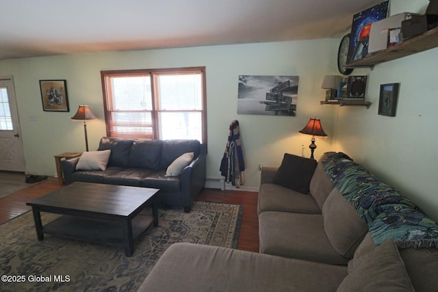 living room with dark wood-type flooring and a baseboard heating unit