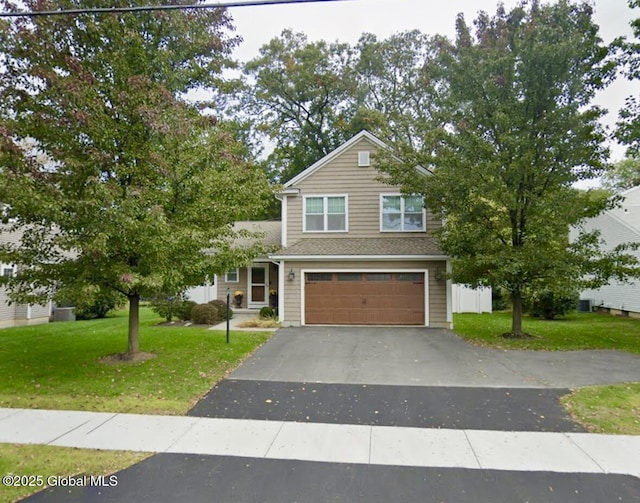 view of front of house featuring a garage and a front lawn