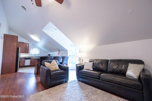 living room with hardwood / wood-style flooring, vaulted ceiling, a healthy amount of sunlight, and ceiling fan