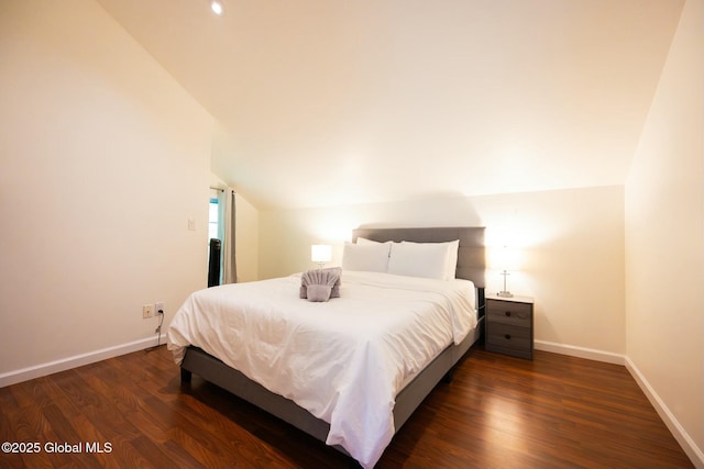 bedroom featuring dark wood-type flooring and lofted ceiling