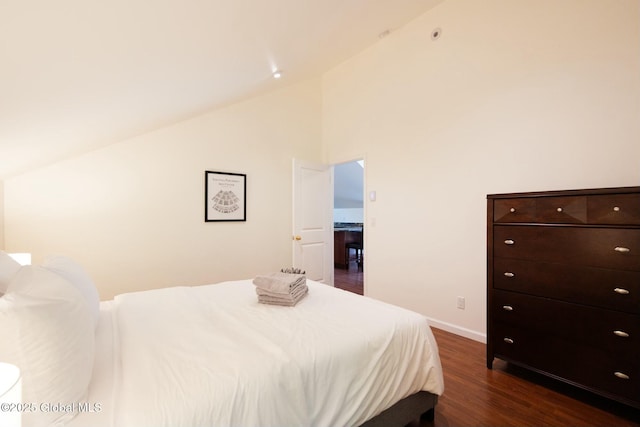 bedroom with high vaulted ceiling and dark hardwood / wood-style floors