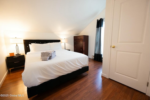 bedroom featuring vaulted ceiling and dark hardwood / wood-style floors