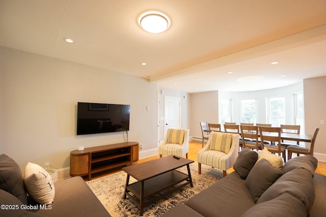 living room featuring hardwood / wood-style floors and a baseboard heating unit