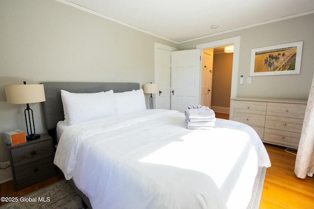 bedroom featuring hardwood / wood-style flooring and ornamental molding