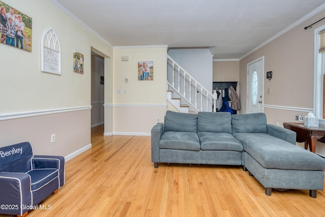 living room featuring crown molding and light hardwood / wood-style floors