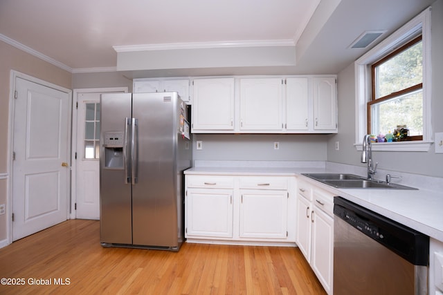 kitchen with white cabinetry, sink, ornamental molding, light hardwood / wood-style floors, and stainless steel appliances