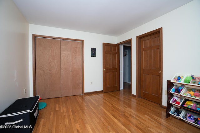 bedroom with wood-type flooring and a closet